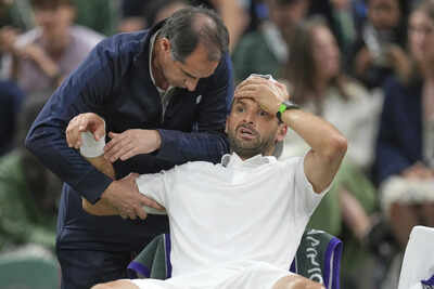 Dimitrov receives medical attention after injury forces Wimbledon retirement