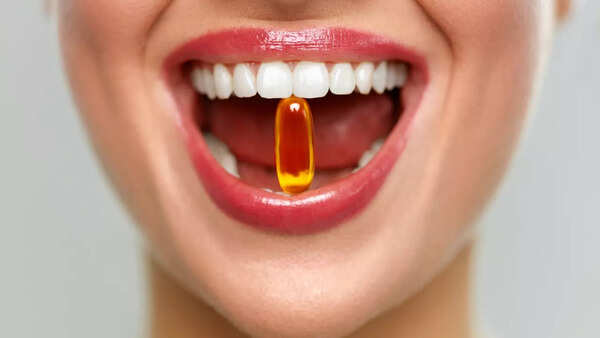 Person holding a Vitamin D supplement.
